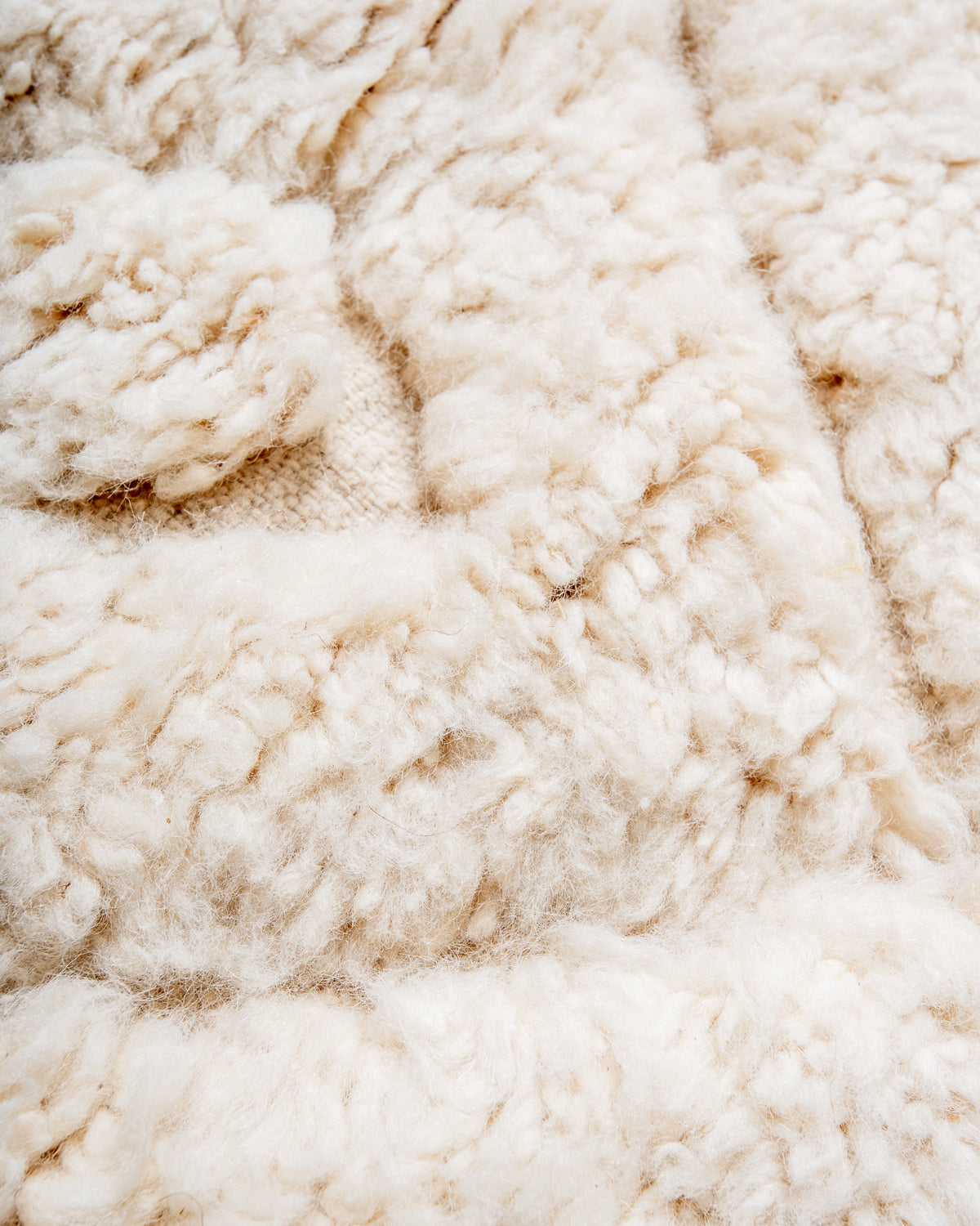 Modern, designer, handcrafted Berber rug from Morocco. Beniourain carpet with minimalist design, natural wool pile and a fluffy texture.